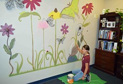RHS Student Puts Finishing Touches on SES Principal's Wall